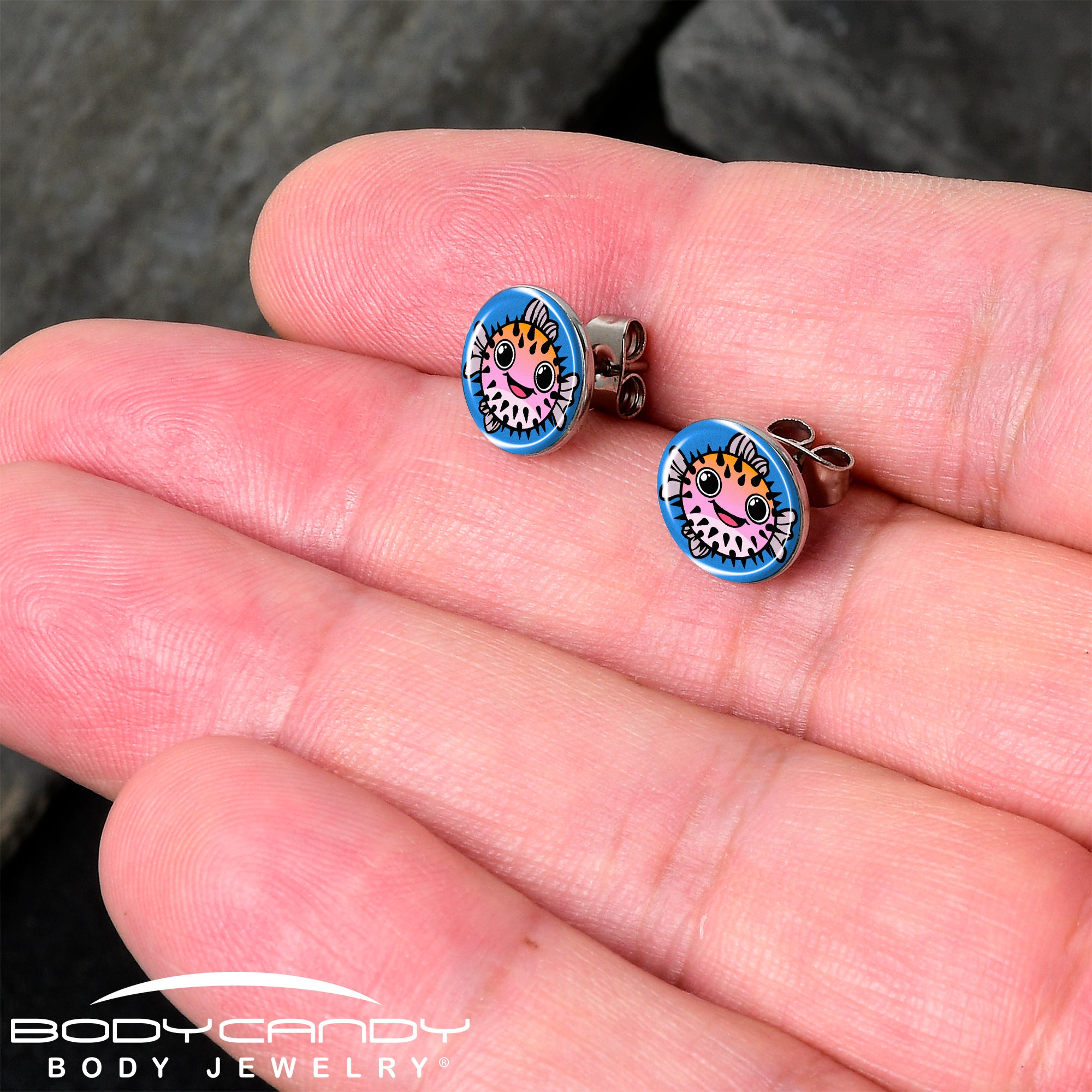 Handmade pink pufferfish earrings with a swimming theme