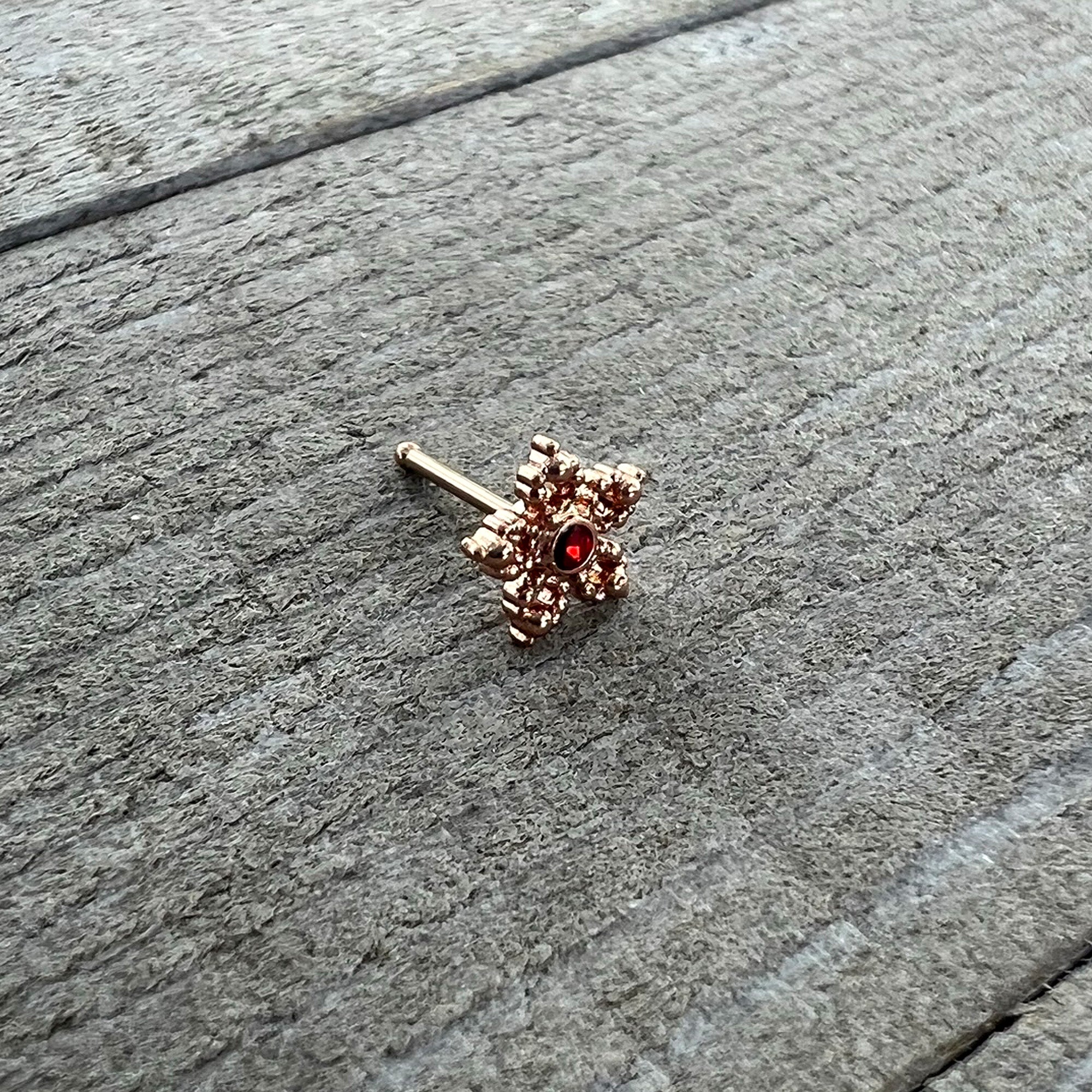 20 Gauge 1/4 Red Gem Rose Gold Tone Textured Snowflake Nose Bone